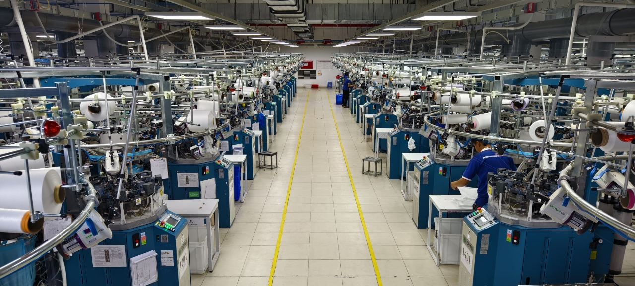 Main knitting aisle — full Santoni hall in operation
